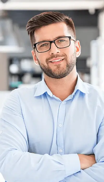 smart young man wearing a blue shirt and glasses